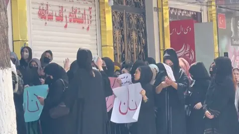 Women stood with posters