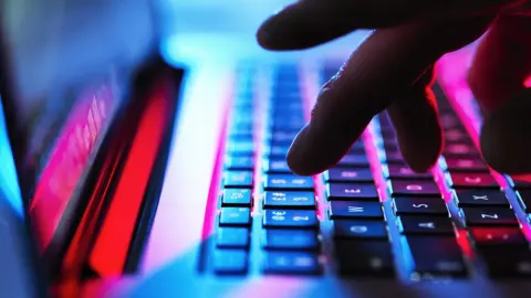 Getty Images A person typing on a laptop keyboard