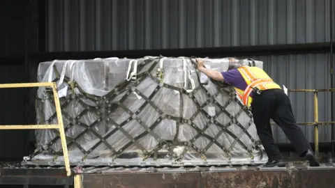 Getty Images Pallets of baby formula are unloaded from a FedEx cargo plane upon arrival at Dulles International Airport on May 25, 2022