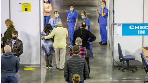 PAUL FAITH/AFP People getting vaccinations at the SSE Arena in Belfast