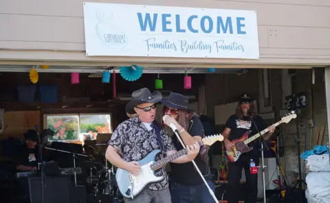 Rock band in a garage at a surrogates retreat