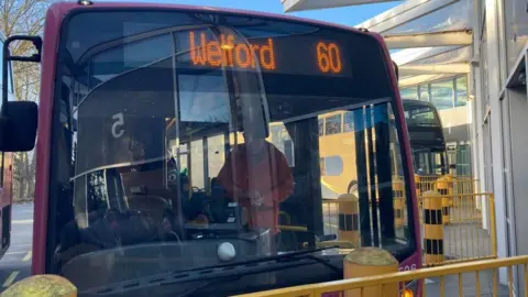 Laura Coffey/BBC Welford 60 bus with a man at the front