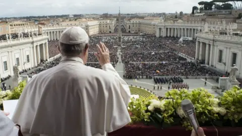 Vatican via AFP Back shot of Pope addressing crowds for Easter address