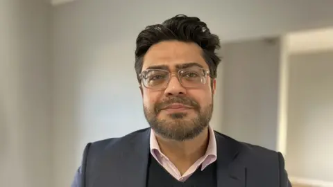 Sam Read/BBC Ashbourne Day Nurseries director Imran Mehdi looking at the camera