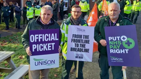 Unison Dave Robb (left) with other striking paramedics