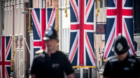 Getty Images Police officers patrol close to Windsor Castle ahead of the royal wedding