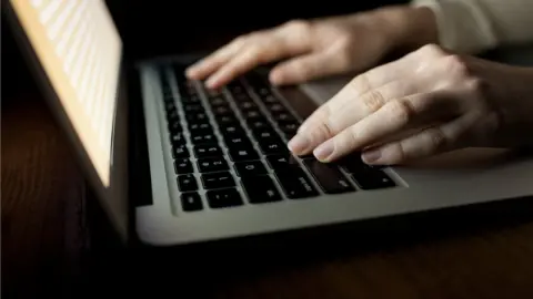 Getty Images Hands on computer