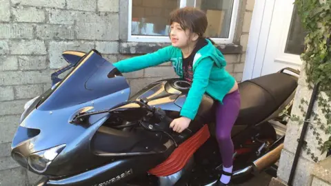 Lia Filby on a bike as a young girl