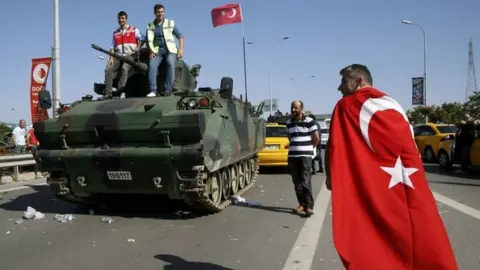Reuters People stand on top of a military armoured vehicle after troops involved in the coup surrendered on the Bosphorus Bridge in Istanbul, Turkey. Photo: 16 July 2016
