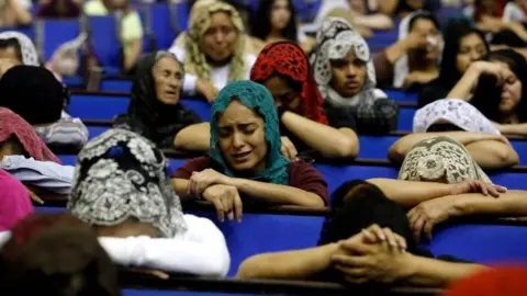 AFP/Getty Images Worshipers pray for their religious leader at La Luz del Mundo's headquarters in Jalisco, Mexico. Photo: 4 June 2019
