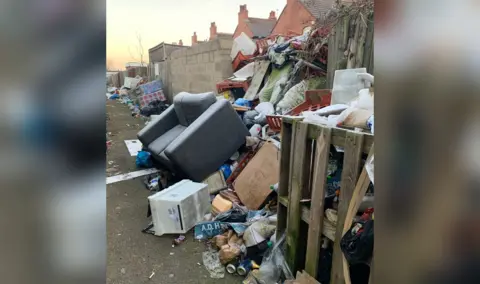 Rubbish piled up in the alleyway