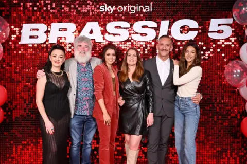 Anthony Devlin/Getty Images for Sky (l-r) Bronagh Gallagher, Steve Evets, Bhavna Limbachia, Joanna Higson, Neil Ashton and Michelle Keegan at The Big Brassic Birthday Bash