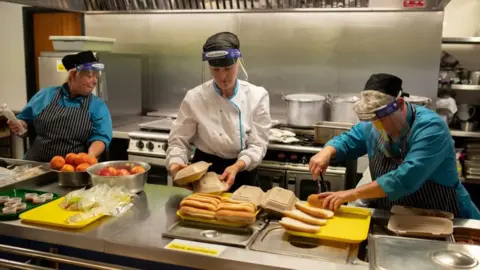 Getty Images Kitchen staff prepare school lunches for pupils