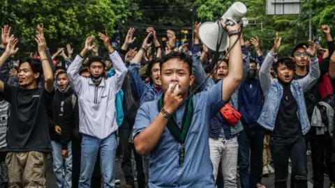 Getty Images Protestors outside Indonesia's parliament on Tuesday.