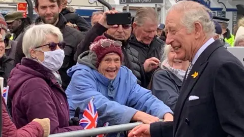 Prince Charles laughs with well wishers on Southend Pier