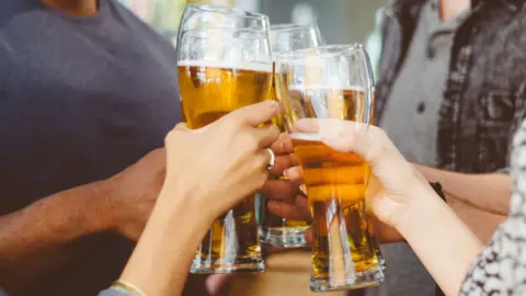 Getty Images People drinking beer