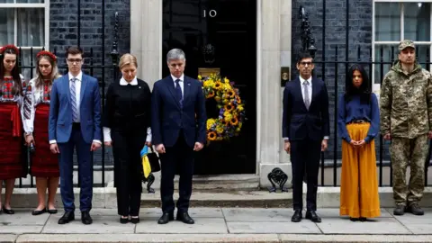 Reuters Rishi Sunak was joined for a minute's silence by his wife Akshata Murthy, Ukrainian Ambassador to UK Vadym Prystaiko and his wife Inna Prystaiko