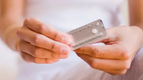 Alamy Woman holding the morning after pill