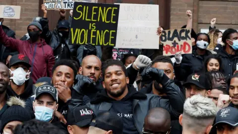 Reuters Boxer Anthony Joshua joined protesters in Watford