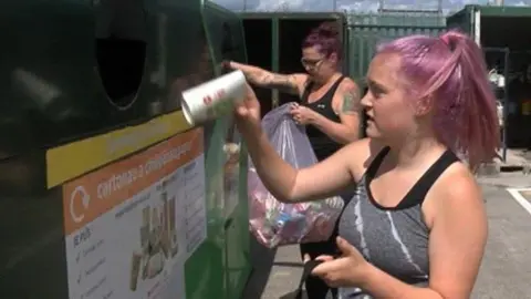 Recycling a paper cup in Swansea