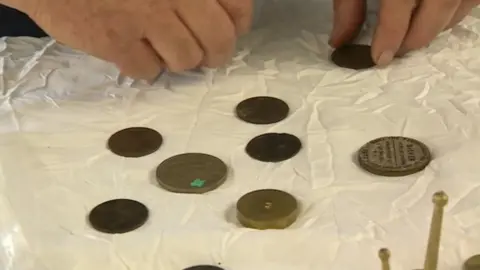 Coins used to regulate the pendulum