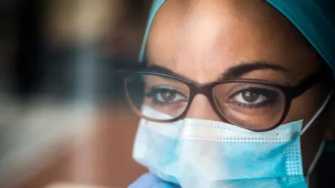 Getty Images picture of person using a surgical mask