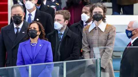 Getty Images (Left to right) Doug Emhoff, Vice-President Kamala Harris, Cole Emhoff, Ella Emhoff, and former Vice President Mike Pence watch on as Lady Gaga sings the national anthem at the inauguration of US President Joe Biden in Washington, DC last week