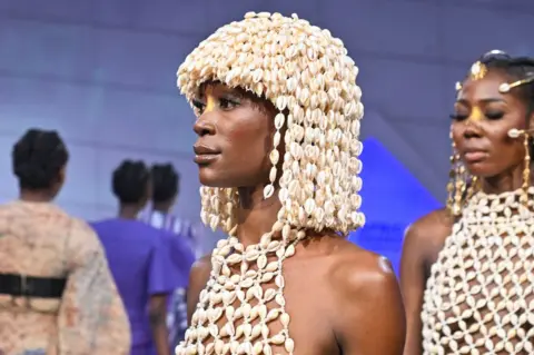 ISSOUF SANOGO/AFP A model presents a creation from Ivorian stylist Lafalaise Dion.