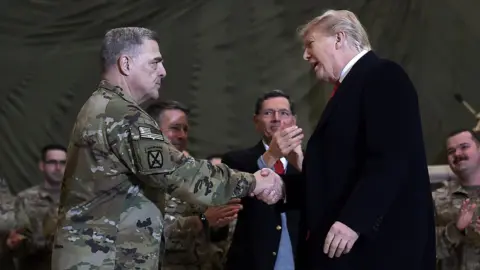 Getty Images President Trump shaking hands with Joint Chiefs Chairman General Mark Milley at Bagram Air Field in Afghanistan on Thanksgiving