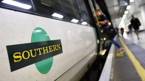 European Photopress Agency Passenger boarding Southern Rail train at Victoria Station.