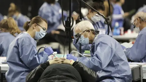 Getty Images A patient receives free dental care at a charity clinic in Seattle