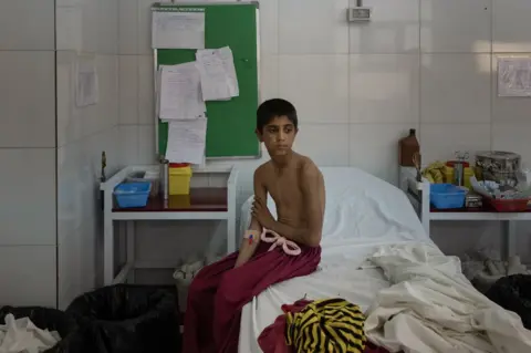 BBC Imran sits in a hospital in Lashkar Gah, where the boys were examined in October. Image: Julian Busch/BBC