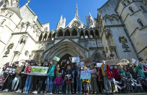 PA Media School children from Yerbury Primary School protest outside the High Court