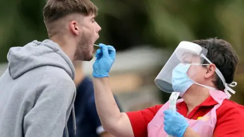 Reuters A person has a swab test for coronavirus