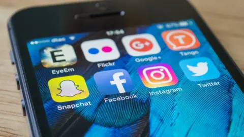 Getty Images Phone with social media apps showing