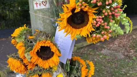 Martin Barber/BBC Flowers at the scene where Jane Blackwell died