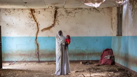 Kate Stanworth Sahra and her granddaughter in an old building at the site of Hartisheik refugee camp in Ethiopia