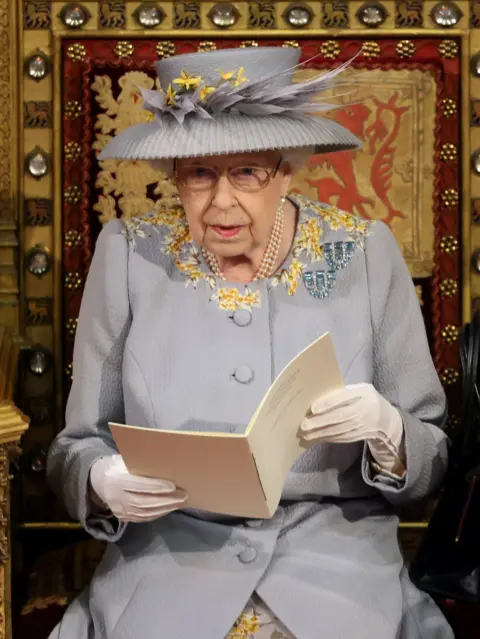 PA Media Queen Elizabeth II delivers a speech from the throne in House of Lords at the Palace of Westminster in London