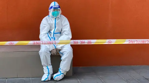 Reuters Shanghai worker in protective clothing