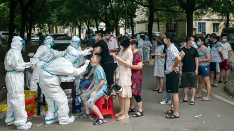 Getty Images Residents wait in the all-inclusive Covid-19 test in Wuhan