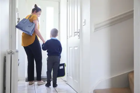 Getty Images Boy leaves for first day at school