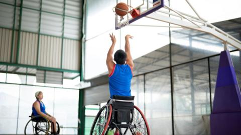 Wheelchair users playing basketball