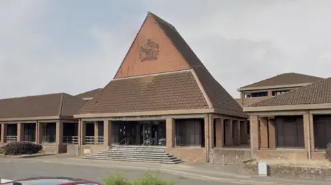 A Google Street image of a red-bricked building which is Guildford Crown Court.