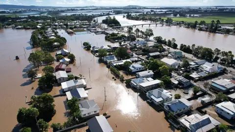 Getty Images An aerial drone view of houses inundated by floodwater on March 07, 2022 in Woodburn, Australia