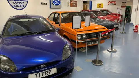 Car museum showing classic cars lined up in a row