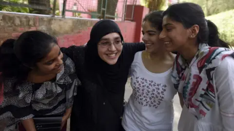 Getty Images A Muslim mother with her daughter and her friends celebrates at St. Thomas School after the class 10th CBSE result announced, on June 3, 2016 in New Delhi, India.