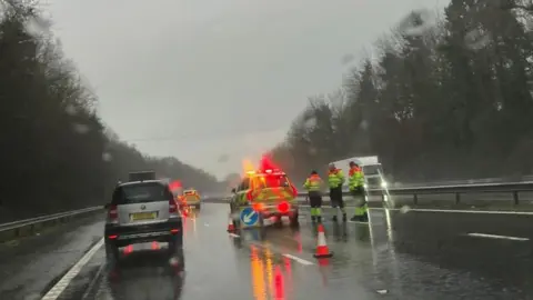 A general view of the M5 in Devon showing cars and emergency vehicles.
