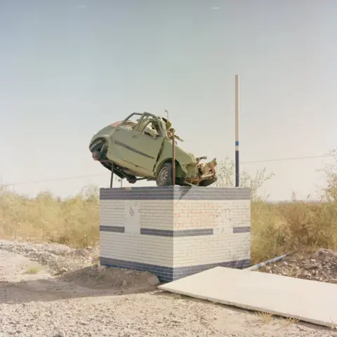 BOYUAN ZHANG A car on a plinth to warn drivers