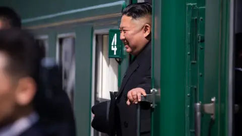 Reuters Kim smiles on train