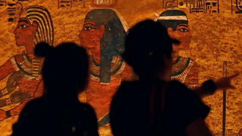 Reuters Visitors look at paintings inside the newly restored tomb of King Tutankhamun in the Valley of the Kings, Egypt (31 January 2019)